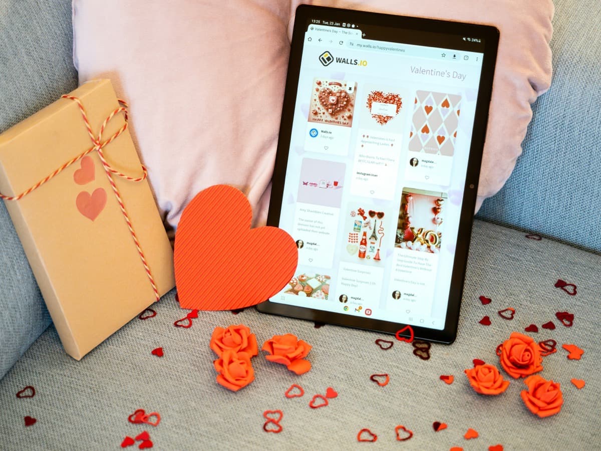 Couple on a video call celebrating their anniversary with candles and a shared dinner across the distance